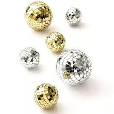 several shiny disco balls on a white background