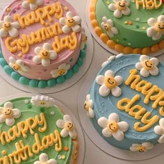 four decorated birthday cakes sitting on top of a table