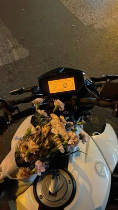 a close up of a motorcycle with flowers on it