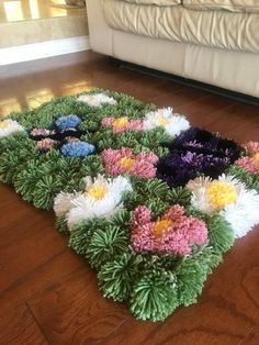 the rug is made up of flowers on the floor in front of a white couch