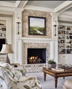 a living room filled with furniture and a fire place under a painting on the wall