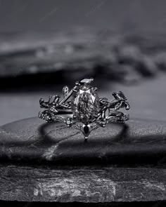 a close up view of a fancy ring on top of a rock