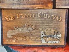 two wooden crates sitting side by side on top of each other, one has a label that says le petit cheval