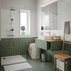 a bathroom with green tile and white walls