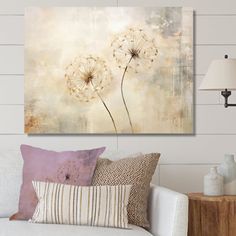 a living room scene with focus on the dandelion canvas wall art above the couch