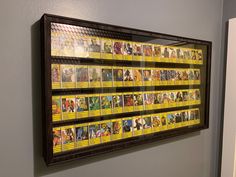 a wall mounted display with comic books on it's sides and an open door in the background