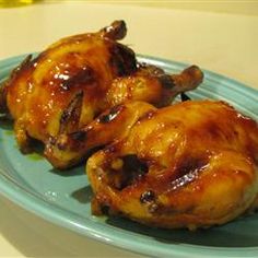 two pieces of cooked chicken on a blue plate