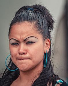 a woman with large hoop earrings on her face