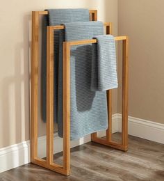 three towels are stacked on top of each other in front of a wall mounted towel rack