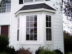 a white house with black roof and windows