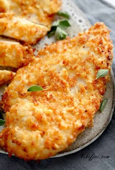 chicken parmesan on a plate with sauce and herbs