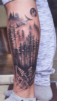 a man with a forest tattoo on his leg