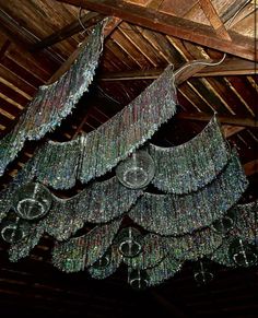 a chandelier hanging from the ceiling in a barn