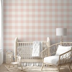 a baby's room with pink and white checkered wallpaper, rocking chair and crib