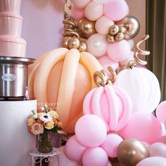 balloons, flowers and other decorations are on display in a room that is decorated for a baby shower