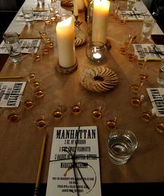 a long table with candles and menus on it