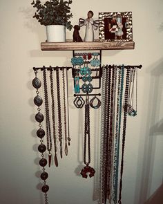 a wall mounted jewelry rack with various necklaces