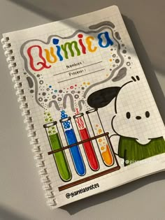 a spiral notebook with an image of a dog holding test tubes filled with colored liquid