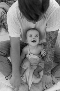 a man kneeling down next to a baby