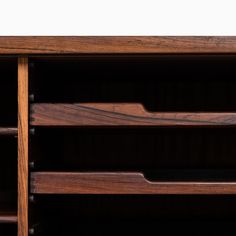 a close up of a wooden shelf with drawers