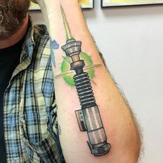 a man with a tattoo on his arm has a green light coming out of it