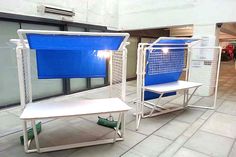 two blue and white chairs sitting next to each other in front of a store window