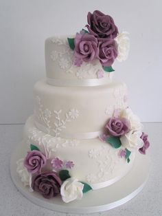 three tiered wedding cake with purple and white flowers