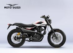 a white and black motorcycle parked on top of a gray background with the words moto guzzi above it