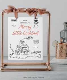 there is a sign that says merry little cocktail on the table next to some bottles