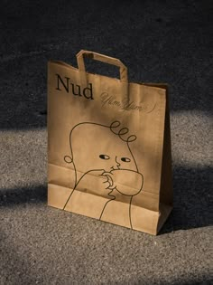 a brown paper bag sitting on the ground