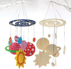 three wooden mobiles hanging from strings in the shape of sun, moon and planets