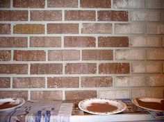 there are two pies sitting on top of a box next to a brick wall