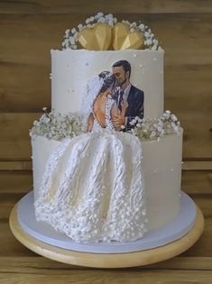 a wedding cake decorated with an image of a bride and groom