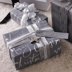 two wrapped presents sitting on the floor next to each other