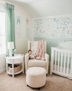 a baby sitting in a chair next to a white crib