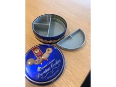 two tins with donuts in them sitting on a table