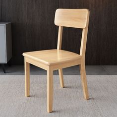 a wooden chair sitting on top of a carpeted floor