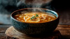 a bowl filled with soup sitting on top of a wooden table