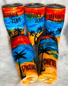 four painted glass tumbles with the names jamaica and two palm trees on each side