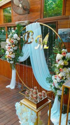 a decorated stage with flowers and ribbons