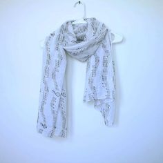 a white scarf with musical notes on it