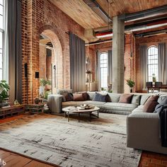 an industrial living room with brick walls and exposed ceilings, large sectional couches, round coffee table