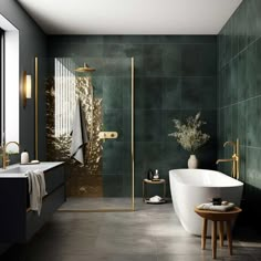 a modern bathroom with green tile and gold accents on the shower, tub, and sink