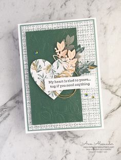 a close up of a card with flowers on it and a heart shaped dieing