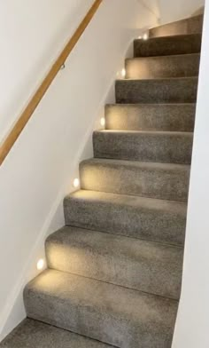 some stairs with lights on them in a house