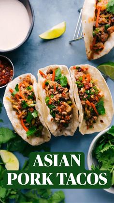 three tacos with meat, carrots and cilantro on a blue surface