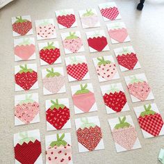 patchwork strawberry quilts laid out on the floor to be made into wall hangings