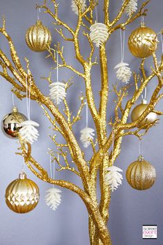 a gold tree with ornaments hanging from it