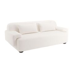 a white couch sitting on top of a wooden floor