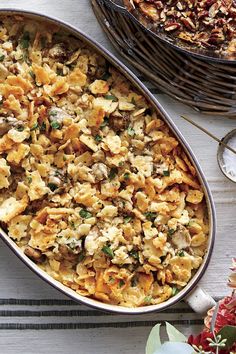 a casserole dish filled with pasta and vegetables on top of a white table